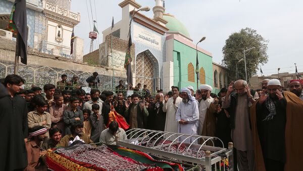 Men and relatives gather to attend funeral prayers for victims killed in a suicide blast at the tomb of Sufi saint Syed Usman Marwandi, also known as the Lal Shahbaz Qalandar shrine, during a funeral in Sehwan Sharif, Pakistan's southern Sindh province - Sputnik International