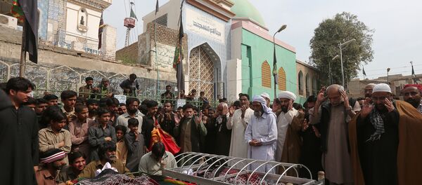 Men and relatives gather to attend funeral prayers for victims killed in a suicide blast at the tomb of Sufi saint Syed Usman Marwandi, also known as the Lal Shahbaz Qalandar shrine, during a funeral in Sehwan Sharif, Pakistan's southern Sindh province Men and relatives gather to attend funeral prayers for victims killed in a suicide blast at the tomb of Sufi saint Syed Usman Marwandi, also known as the Lal Shahbaz Qalandar shrine, during a funeral in Sehwan Sharif, Pakistan's southern Sindh province - Sputnik International