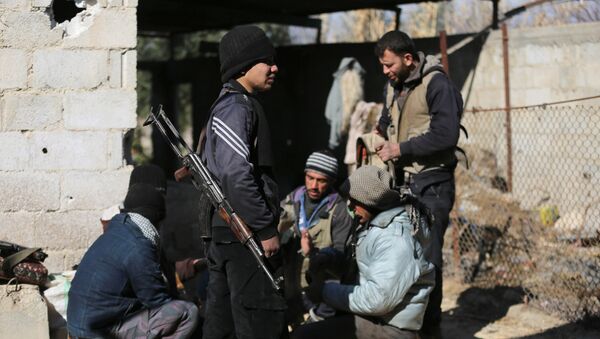 Fighters from the Jaish al-Islam (Islam Army), the foremost rebel group in Damascus province who fiercely oppose both the Syrian regime and the Islamic State group, gather inside a building on the frontline in the town of Bilaliyah, east of the capital Damascus, on February 4, 2017 - Sputnik International