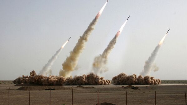 A handout picture released on the news website and public relations arm of Iran's Revolutionary Guards, Sepah News, shows an image apparently digitally altered to show four missiles rising into the air instead of three during a test-firing at an undisclosed location in the Iranian desert (File) - Sputnik International