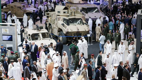 A picture taken on February 19, 2017 shows a general view of visitors walking in a showroom displaying armoured military vehicles during the opening of the International Defence Exhibition and Conference (IDEX) in the Emirati capital Abu Dhabi - Sputnik International