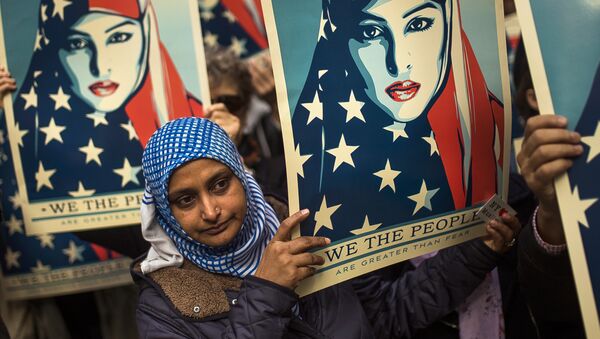 People carry posters during a rally against President Donald Trump's executive order banning travel from seven Muslim-majority nations, in New York's Times Square, Sunday, Feb. 19, 2017. - Sputnik International