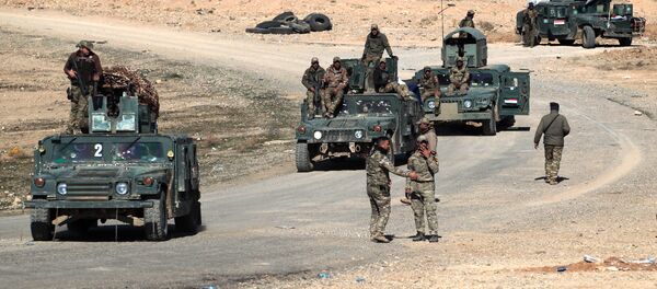 Iraqi security forces drive in the village of al-Buseif, south of Mosul, after they recaptured the village from the control of the Islamic State (IS) group on February 21, 2017, during the ongoing military offensive to retake the western side of Mosul - Sputnik International