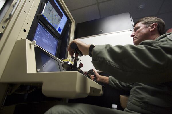 Col. Charles W. Manley, commander of the 163d Maintenance Group,163d Reconnaissance Wing, pilots a training simulator for the US Air Force's MQ-1 Predator, at the March Air Reserve Base in Riverside County, California, June 25, 2008. Col. Charles W. Manley, commander of the 163d Maintenance Group,163d Reconnaissance Wing, pilots a training simulator for the US Air Force's MQ-1 Predator, at the March Air Reserve Base in Riverside County, California, June 25, 2008. - Sputnik International