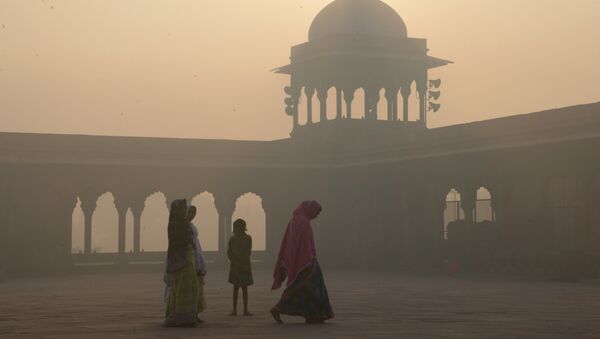 This file photo taken on November 3, 2016 shows Indian women walking as smog envelops the Jama Masjid mosque in the old quarters of New Delhi - Sputnik International