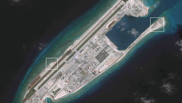 A satellite image shows what CSIS Asia Maritime Transparency Initiative says appears to be anti-aircraft guns and what are likely to be close-in weapons systems (CIWS) on the artificial island Fiery Cross Reef in the South China Sea in this image released on December 13, 2016 - Sputnik International