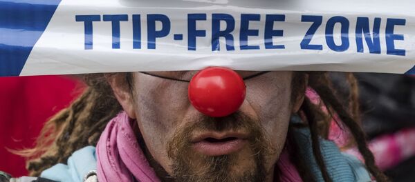 A man covers his eyes with a banner as he protests against international trade agreements TTIP and CETA in front of EU headquarters in Brussels on Thursday, Oct. 27, 2016 A man covers his eyes with a banner as he protests against international trade agreements TTIP and CETA in front of EU headquarters in Brussels on Thursday, Oct. 27, 2016 - Sputnik International