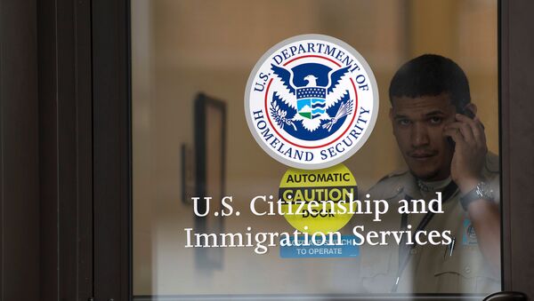 A security guard looks out of the U.S. Citizenship and Immigration Services offices in New York, U.S. (File) - Sputnik International