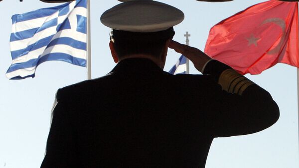 Greece's military Adm. Panagiotis Chinofotis salutes during the Turkish national anthem as the Greek, left, and Turkish flags wave at the Greek Defense Ministry in Athens on Thursday, Nov. 2, 2006 - Sputnik International