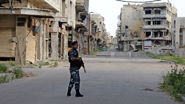 A police officer patrols a street in Homs. (File) - Sputnik International