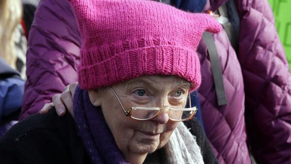 A woman wearing a pink cap marches in a women's march that brought tens of thousands Saturday, Jan. 21, 2017, in Seattle. Women across the Pacific Northwest marched in solidarity with the Women's March on Washington and to send a message in support of women's rights and other causes. - Sputnik International