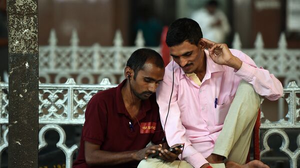 Indian commuters use their smartphones following the introduction of a new free Wi-Fi Internet service in Mumbai's central railway station on January 22, 2016 - Sputnik International