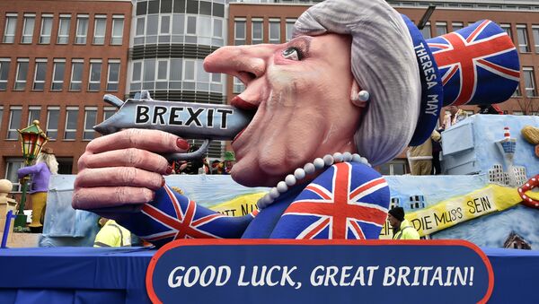 A carnival float depicts British Prime Minister Theresa May with a gun and the writing 'Brexit' on it prior to the traditional carnival parade in Duesseldorf, Germany, on Monday, Feb. 27, 2017. - Sputnik International