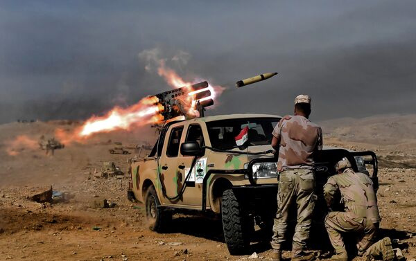 Members of the Iraqi army's 9th Division fire a multiple rocket launcher from a hill in Talul al-Atshana, on the southwestern outskirts of Mosul, on February 27, 2017, during an offensive to retake the city from Islamic State (IS) group fighters - Sputnik International