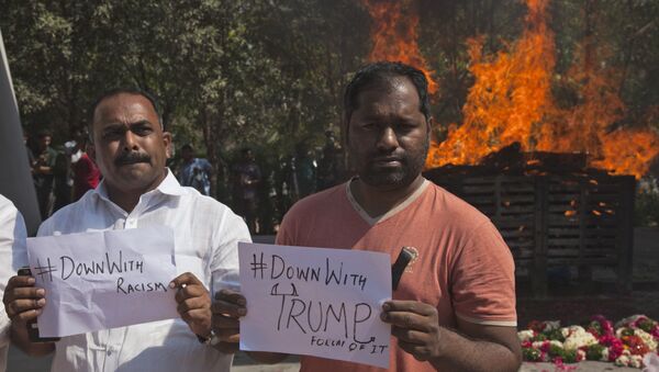 Indians hold placards in front of the cremation pyre of Srinivas Kuchibhotla, a 32-year-old engineer who was killed in an apparently racially motivated shooting in a crowded Kansas bar, at a crematorium in Hyderabad, India, Tuesday, Feb.28, 2017 - Sputnik International