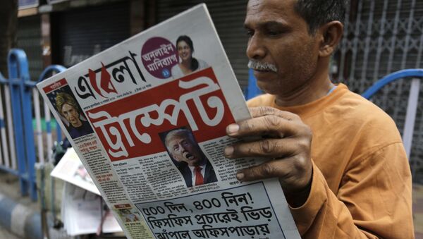 An Indian man reads a Bengali language newspaper that has the words 'Trumped headlined to refer to U.S President-elect Donald Trump's election victory in Kolkata, India, Thursday, Nov. 10, 2016 - Sputnik International
