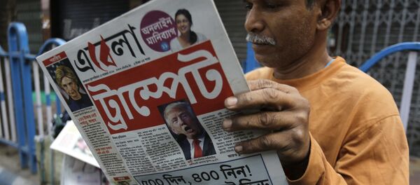 An Indian man reads a Bengali language newspaper that has the words 'Trumped headlined to refer to U.S President-elect Donald Trump's election victory in Kolkata, India, Thursday, Nov. 10, 2016 An Indian man reads a Bengali language newspaper that has the words 'Trumped headlined to refer to U.S President-elect Donald Trump's election victory in Kolkata, India, Thursday, Nov. 10, 2016 - Sputnik International