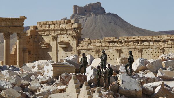Syrian army soldiers stand on the ruins of the Temple of Bel in the historic city of Palmyra, in Homs Governorate (File) - Sputnik International