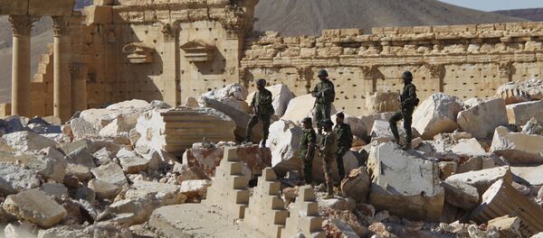 Syrian army soldiers stand on the ruins of the Temple of Bel in the historic city of Palmyra, in Homs Governorate (File) Syrian army soldiers stand on the ruins of the Temple of Bel in the historic city of Palmyra, in Homs Governorate (File) - Sputnik International