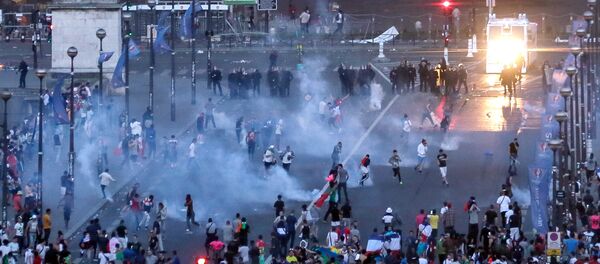 Riot police fire tear gaz canisters during clashes with young troublemakers near the Paris fan zone during the Euro 2016 final soccer match between Portugal and France at the Stade de France, Sunday, July 10, 2016 Riot police fire tear gaz canisters during clashes with young troublemakers near the Paris fan zone during the Euro 2016 final soccer match between Portugal and France at the Stade de France, Sunday, July 10, 2016 - Sputnik International