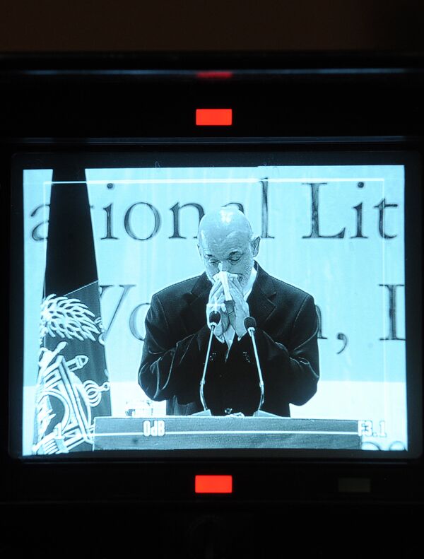 Afghan President Hamid Karzai is seen through the screen of a video camera wipes his tears as he cries at a ceremony at Amani High School in Kabul on September 28, 2010. Afghan President Hamid Karzai is seen through the screen of a video camera wipes his tears as he cries at a ceremony at Amani High School in Kabul on September 28, 2010. - Sputnik International