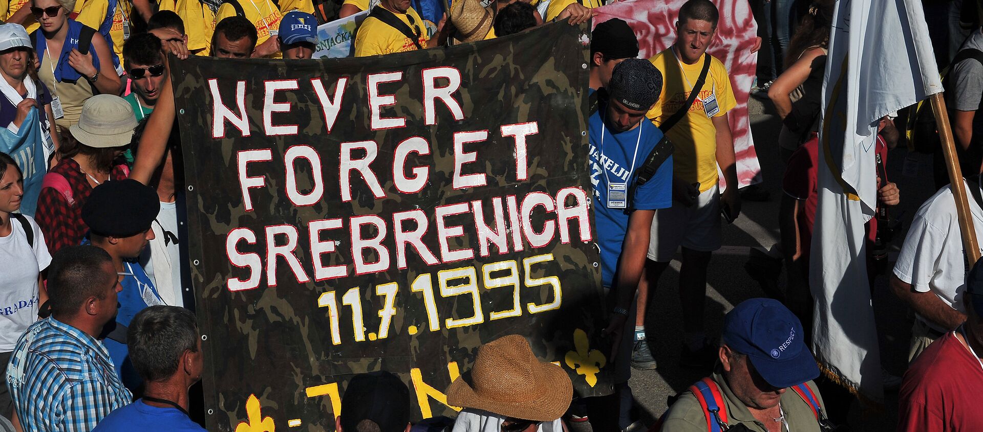 Bosnian protesters hold a banner reading 'never forget Srebrenica' during the Srebrenica Peace March near the city center of Srebrenica on July 10, 2015 - Sputnik International, 1920, 04.03.2017