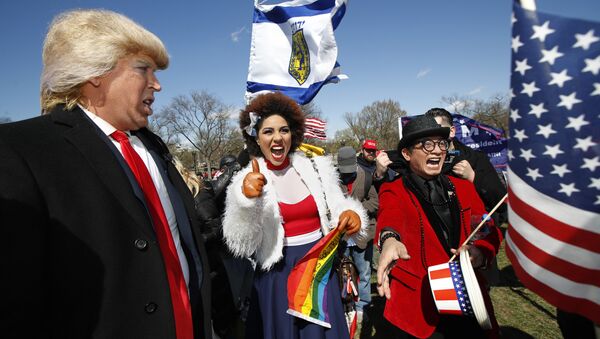 Supporters of President Donald Trump, from left, comedian Dustin Gold from Nashville Tenn., singer Joy Villa and fashion designer Andre Soriano, cheer during a rally organized by the North Carolina-based group Gays for Trump, at the National Mall near the Washington Monument in Washington, Saturday, March 4, 2017. The speakers at the rally talked about immigration, gay rights, and several other issues and later marched from the National Mall to the White House. - Sputnik International