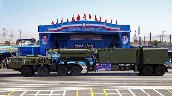In front of the portraits of supreme leader Ayatollah Ali Khamenei, right, and late revolutionary founder Ayatollah Khomeini, left, a long-range, S-300 missile system is displayed by Iran's army during a military parade marking the 36th anniversary of Iraq's 1980 invasion of Iran, in front of the shrine of late revolutionary founder Ayatollah Khomeini, just outside Tehran, Iran - Sputnik International