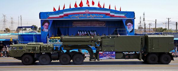 In front of the portraits of supreme leader Ayatollah Ali Khamenei, right, and late revolutionary founder Ayatollah Khomeini, left, a long-range, S-300 missile system is displayed by Iran's army during a military parade marking the 36th anniversary of Iraq's 1980 invasion of Iran, in front of the shrine of late revolutionary founder Ayatollah Khomeini, just outside Tehran, Iran - Sputnik International