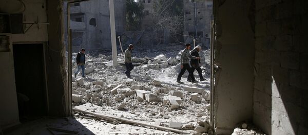 People walk at an area hit by airstrikes in the rebel held besieged Douma neighbourhood of Damascus, Syria. (File) - Sputnik International