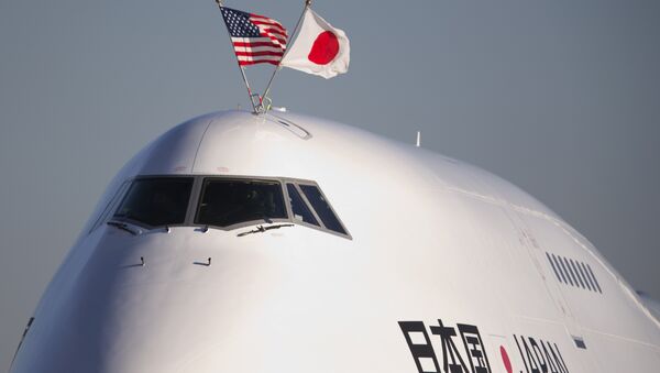 The flags of the United States and Japan are flown atop the plane carrying Japanese Prime Minister Shinzo Abe, as it arrives at Andrews Air Force Base, Md., Thursday, Feb. 21, 2013 - Sputnik International