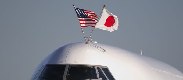 The flags of the United States and Japan are flown atop the plane carrying Japanese Prime Minister Shinzo Abe, as it arrives at Andrews Air Force Base, Md., Thursday, Feb. 21, 2013 - Sputnik International