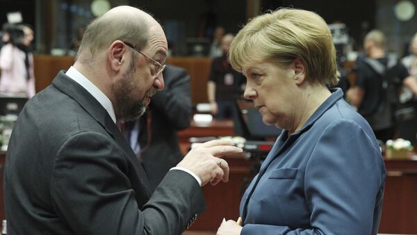 European Parliament President Martin Schulz, left, talks with German Chancellor Angela Merkel, during an EU summit at the European Council building in Brussels. File photo - Sputnik International