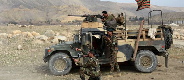 Afghan security force personnel look on from the shelter of a vehicle during an ongoing an operation against Islamic State (IS) militants in Kot district of Nangarhar province on February 16, 2017 Afghan security force personnel look on from the shelter of a vehicle during an ongoing an operation against Islamic State (IS) militants in Kot district of Nangarhar province on February 16, 2017 - Sputnik International