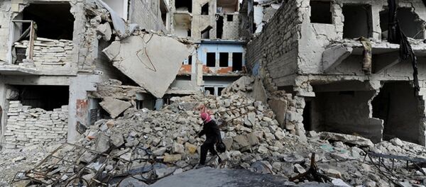 A man walks near damaged buildings in Aleppo, Syria A man walks near damaged buildings in Aleppo, Syria - Sputnik International