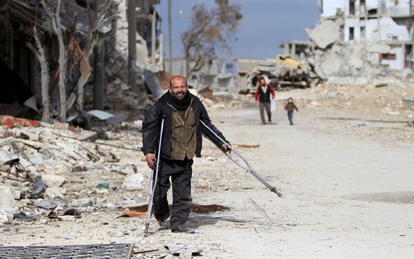 Syrian man walking past damaged buildings in Aleppo - Sputnik International