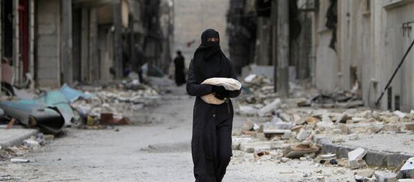 Syrian woman walks past a destroyed building in Aleppo Syrian woman walks past a destroyed building in Aleppo - Sputnik International