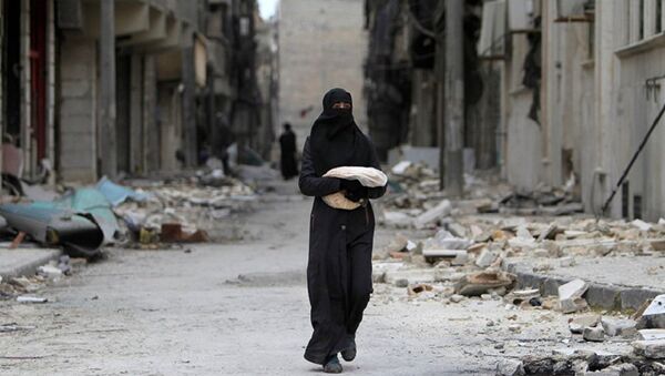 Syrian woman walks past a destroyed building in Aleppo - Sputnik International