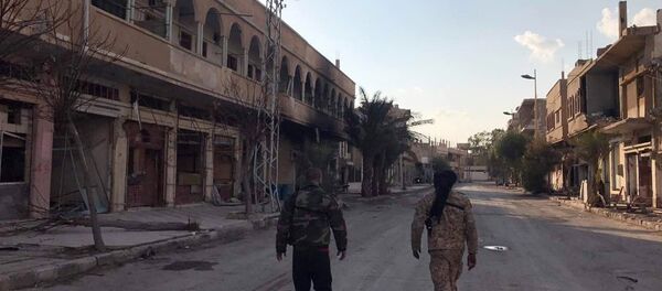Soldiers walk past buildings destroyed during combat activities in the residential part of Ancient Palmyra in Homs Governorate, Syria Soldiers walk past buildings destroyed during combat activities in the residential part of Ancient Palmyra in Homs Governorate, Syria - Sputnik International