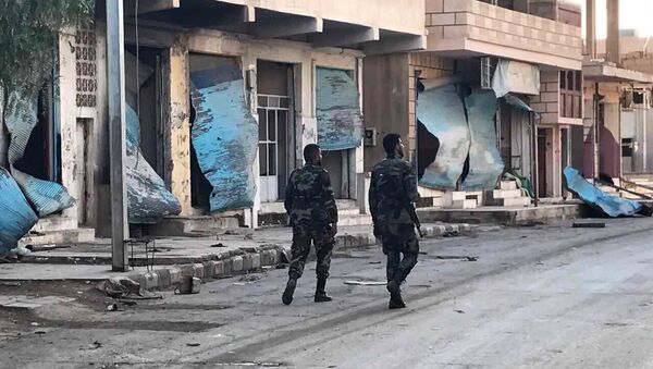 Soldiers walk past buildings destroyed during combat activities in the residential part of Ancient Palmyra in Homs Governorate, Syria - Sputnik International
