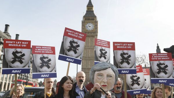 Demonstrators, one dressed in a Theresa May puppet head pose near parliament in London - Sputnik International