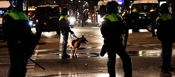 Riot police stand guard during clashes with demonstrators in the streets near the Turkish consulate in Rotterdam, Netherlands March 12, 2017. Riot police stand guard during clashes with demonstrators in the streets near the Turkish consulate in Rotterdam, Netherlands March 12, 2017. - Sputnik International