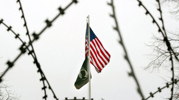 The US flag is seen through barbed wire in front of the US General Consulate in Frankfurt, central Germany. (File) - Sputnik International