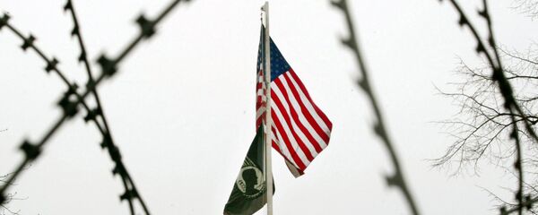 The US flag is seen through barbed wire in front of the US General Consulate in Frankfurt, central Germany. (File) - Sputnik International