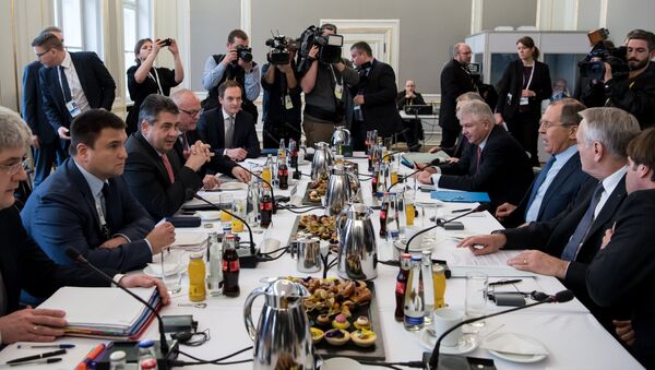 Ukraine's Foreign Minister Pavlo Klimkin (2ndL), German Foreign Minister Sigmar Gabriel (3rdL), French Foreign Minister Jean-Marc Ayrault (2ndR) and Russian Foreign Minister Sergei Lavrov (3rdR) sit down for talks in the so-called Normandy format at the 53rd Munich Security Conference (MSC) at the Bayerischer Hof hotel in Munich, southern Germany, on February 18, 2017 - Sputnik International