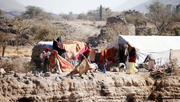 People are pictured near their tent at a camp for internally displaced people in Dharawan, near the capital Sanaa, Yemen February 28, 2017 - Sputnik International