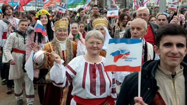 People attend a rally marking the third anniversary of Crimea voting to leave Ukraine and join the Russian state in central Simferopol on March 16, 2017 - Sputnik International