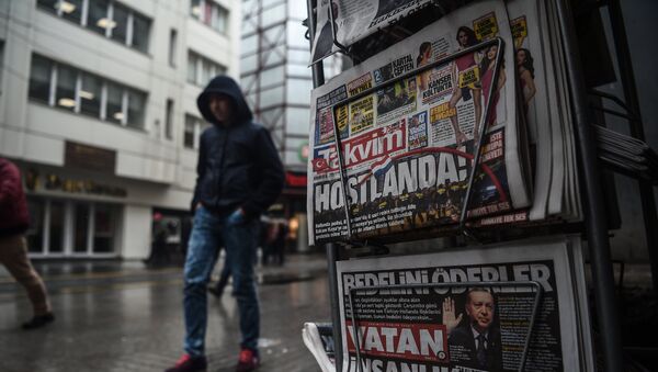 A person walks past a newspaper stand showing their front pages bearing headlines concerning diplomatic tensions between Turkey and The Netherlands, on display in Istanbul on March 13, 2017 - Sputnik International