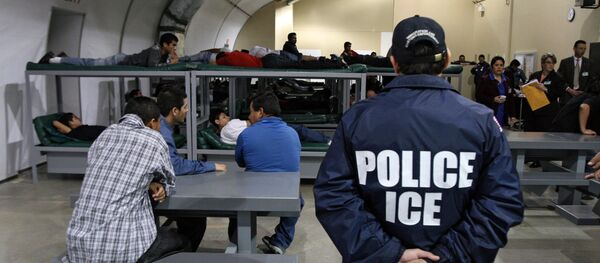 An Immigration and Customs Enforcement (ICE) officer guards a group of 116 Salvadorean immigrants that wait to be deported,at Willacy Detention facility in Raymondville, Texas on December 18, 2008 An Immigration and Customs Enforcement (ICE) officer guards a group of 116 Salvadorean immigrants that wait to be deported,at Willacy Detention facility in Raymondville, Texas on December 18, 2008 - Sputnik International