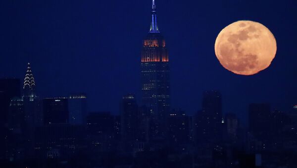 The full moon rises behind the New York City skyline, including the Empire State Building, centre, and the Chrysler Building, left, as seen from downtown Newark, NJ, Sunday, 12 March 2017.  - Sputnik International